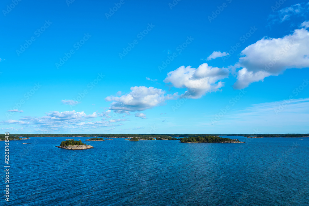 Sea scape with cloudy blue sky.