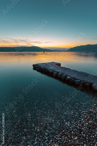 Sunset in Kotor bay. Pier on the beach at sunset. Montenegro.
