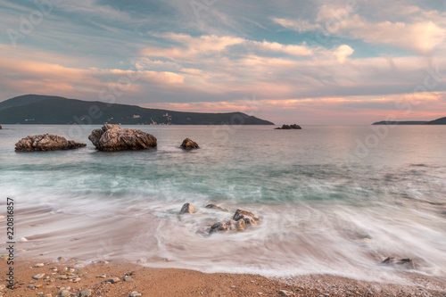 Fototapeta Naklejka Na Ścianę i Meble -  Sunset and waves on the shore. Montenegro.