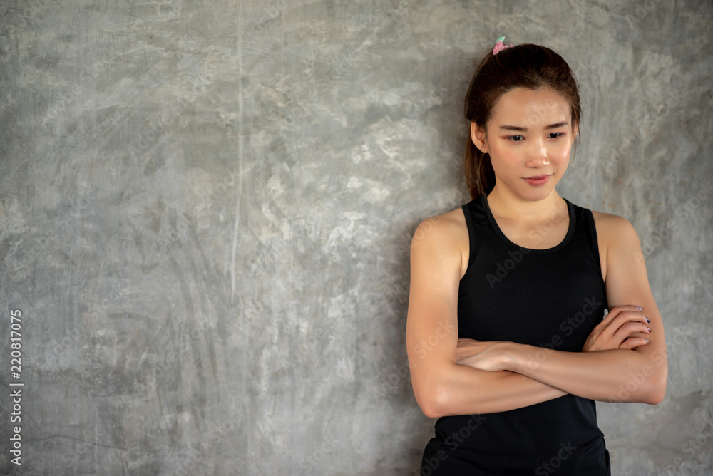 Young sporty woman relaxing after training at gym. Young sporty woman relaxing after training at gym.