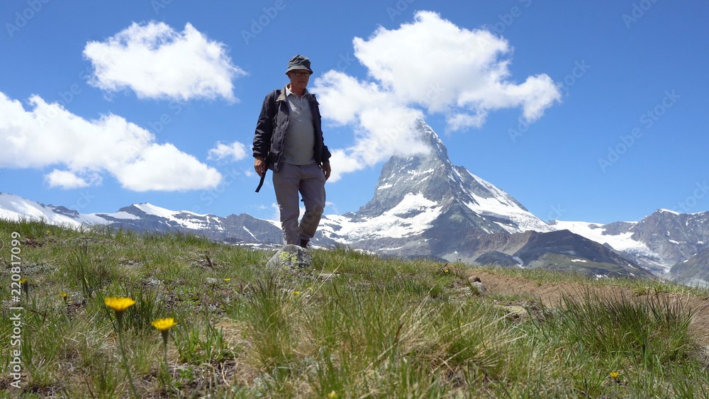 Old Healthy Man Hiking with Mountains in Background Old Healthy Man Hiking with Mountains in Background