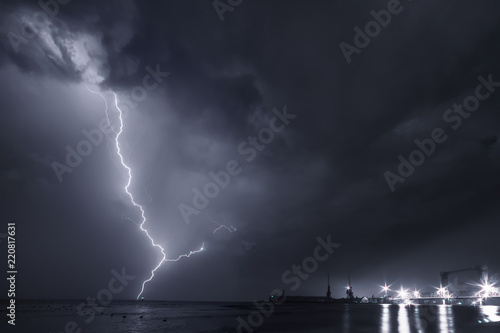 Summer storm, dramatic sky and amazing lightnings over the ocean. natural background. black and white toned picture