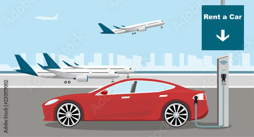 The rental electric car car is charging at the charging station for electric vehicles. Rent a car in the airport. 