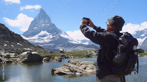 Man Taking Pictures of Landscape With Mobile Smart Phone