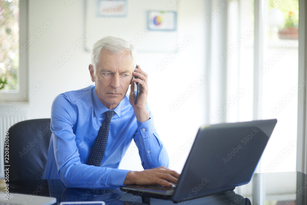 Businessman using his mobile phone Businessman using his mobile phone