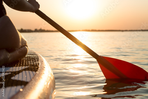 Φωτογραφία Young sexy woman swimming on stand up paddle board