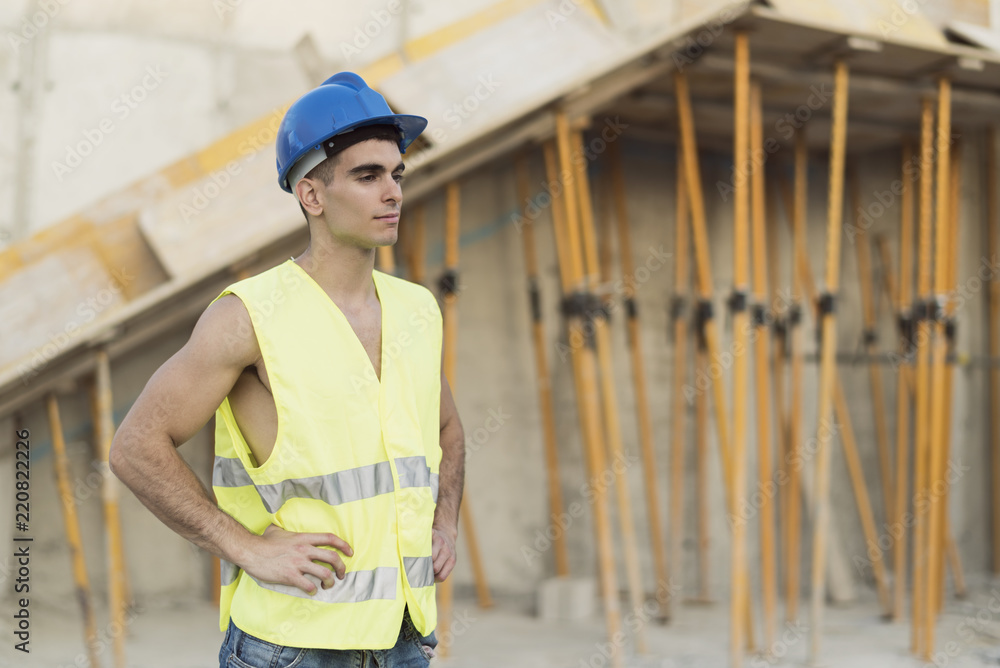 Construction worker posing in construction site Construction worker posing in construction site