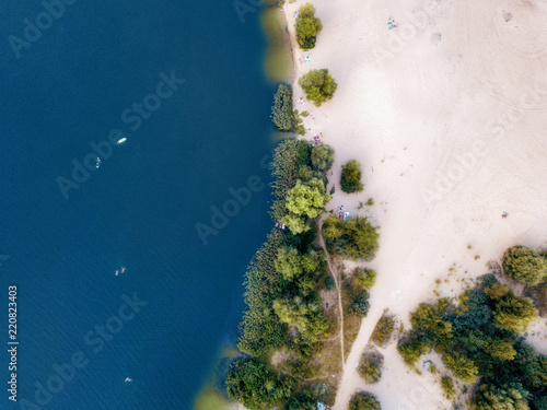 arial veiw of sandy beach and blue sea (ocean, lake, river). drone shot