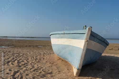 Turquoise blue fishing boat at sunset in Egypt