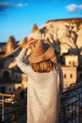 woman traveler in hat and looking at mountains. travel, lifestyle, instagram concept