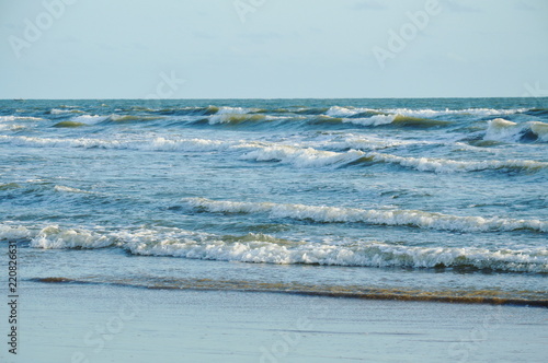 landscape of sea and water surf to beach in sunset