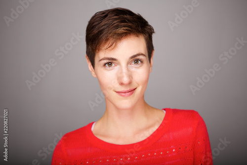 Close up portrait of beautiful young woman smirking