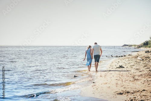 Happy couple running on the beach © Александра Вишнева