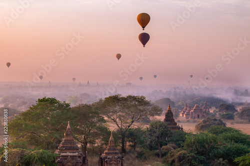 stunning sunrise over the plain of Bagan Myanmar (Burma) with balloons in the morning fog