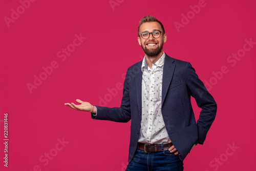 Studio shot of attractive brunette business man with glasses, in casual shirt, stylish black jacket, smiling.