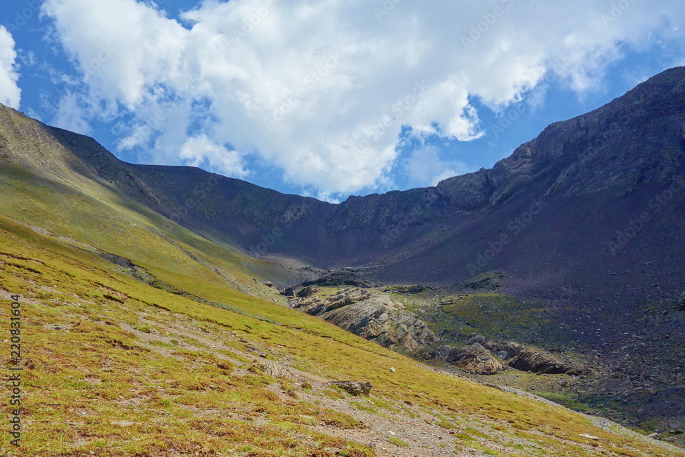 Grand alpine mountain range during summer on a hiking trail leading from Juta to Chaukhi pass, Caucasus mountains, Georgia
