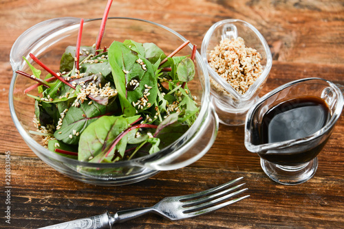 a salad of fresh greens and sesame seeds with soy sauce, Asian national cuisine photo