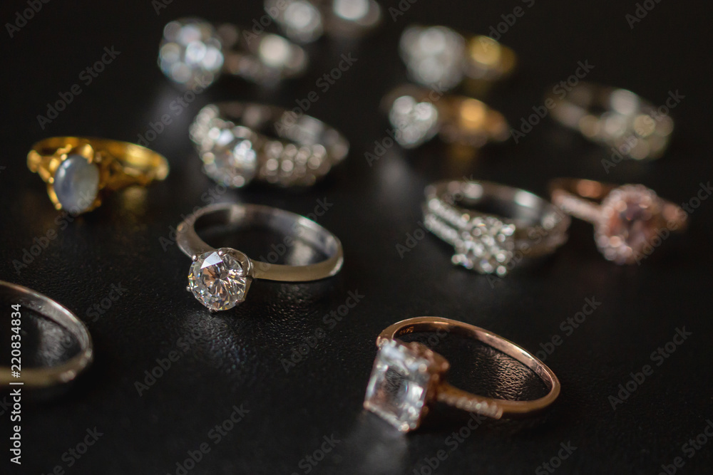 Jewelry diamond rings on black background close up Jewelry diamond rings on black background close up