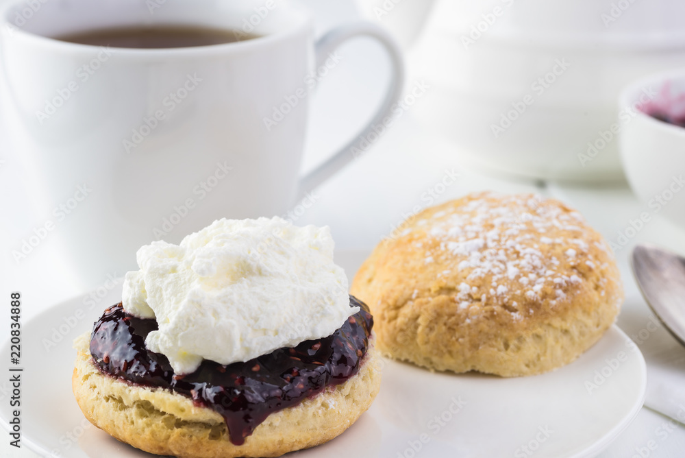 Traditional English cream tea. English scones with clotted cream and raspberry jam.