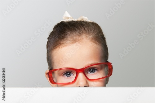 Little smiling girl with white blank close up on  background