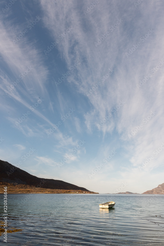 Small wooden rowboat moored in a Tromso fjord