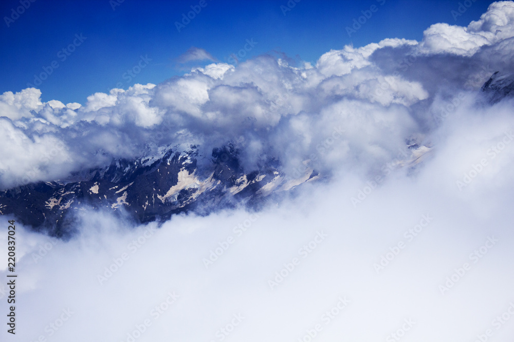 Mountains hiding in clouds, view from Elbrus side