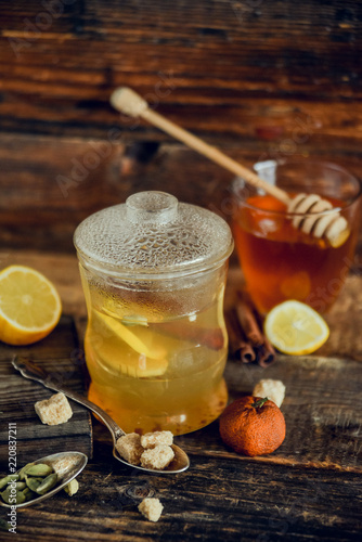 Vitamin tea with lemon and honey, ginger and spices. The concept of spring beriberi and colds. on a wooden table
