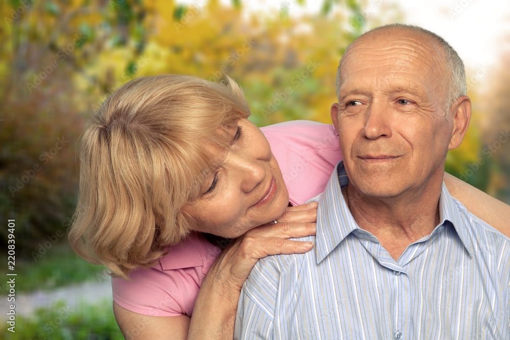 Portrait of happy senior couple smiling in park Portrait of happy senior couple smiling in park