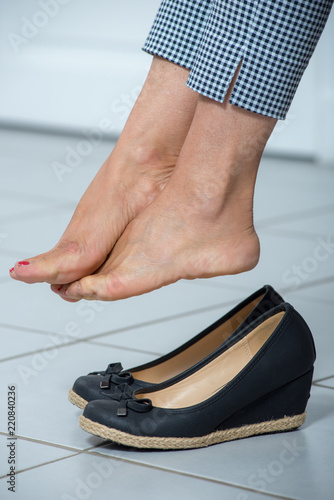 woman relaxes her feet at the end of the day