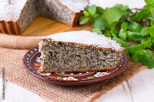 Homemade cake with poppy seeds on table