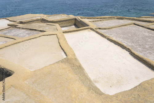 Traditional Maltese salt evaporation in city Zebbug, Gozo / Malta. Square salt pans is former method of salt production on site next battery Qolla l-Bajda.