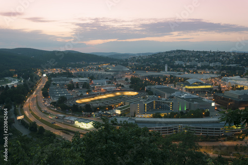 Amazing top view on Brno city, Czech republic at summer evening. Area around exhibition center, road, buildings, hotels, velodrome and houses. Breathtaking dark time with city lights.