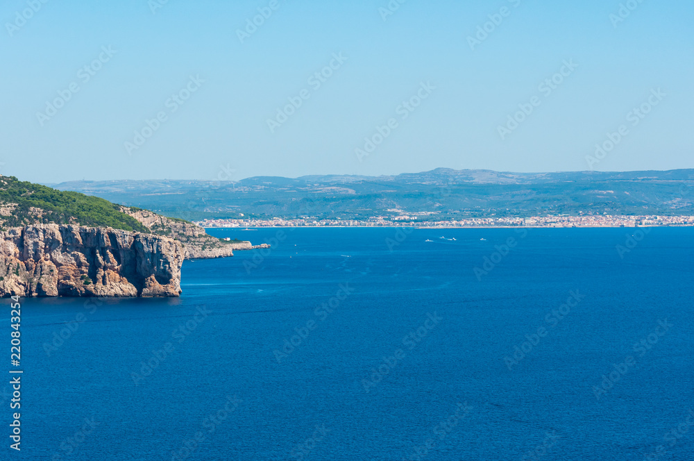 Landscape of sardinian coast with city of alghero in the background