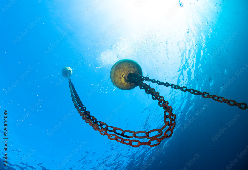Boat chain and yellow buoy anchor from underwater Stock Photo
