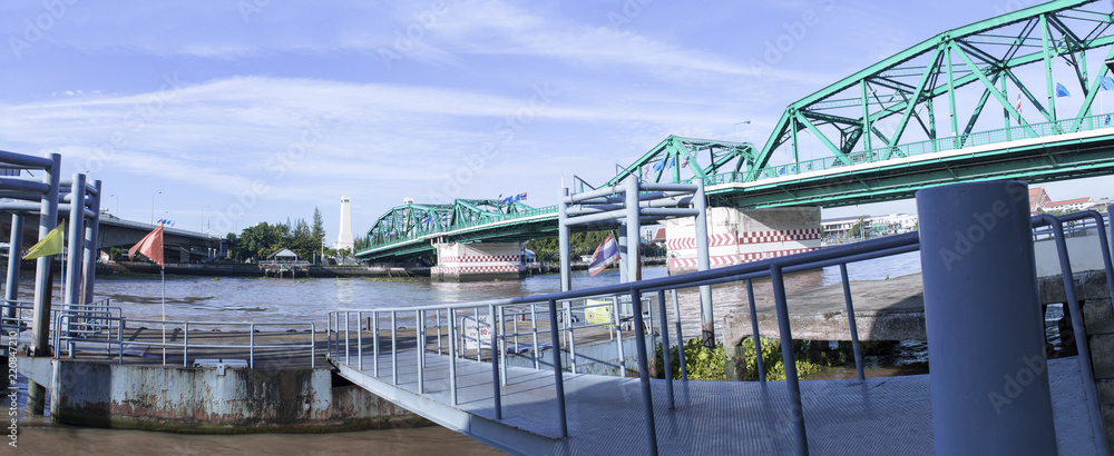 Naklejka premium Phra Phuttha Yodfa Bridge, Memorial Bridge in Thailand.Morning light cloudy and blue sky.Copy right and panorama.
