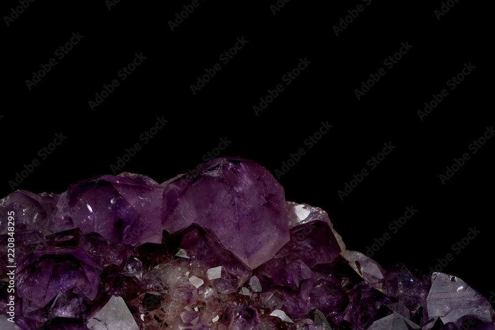 part of mineral purple Amethyst crystal quartz texture background with black isolated background and have some space for write wording part of mineral purple Amethyst crystal quartz texture background with black isolated background and have some space for write wording