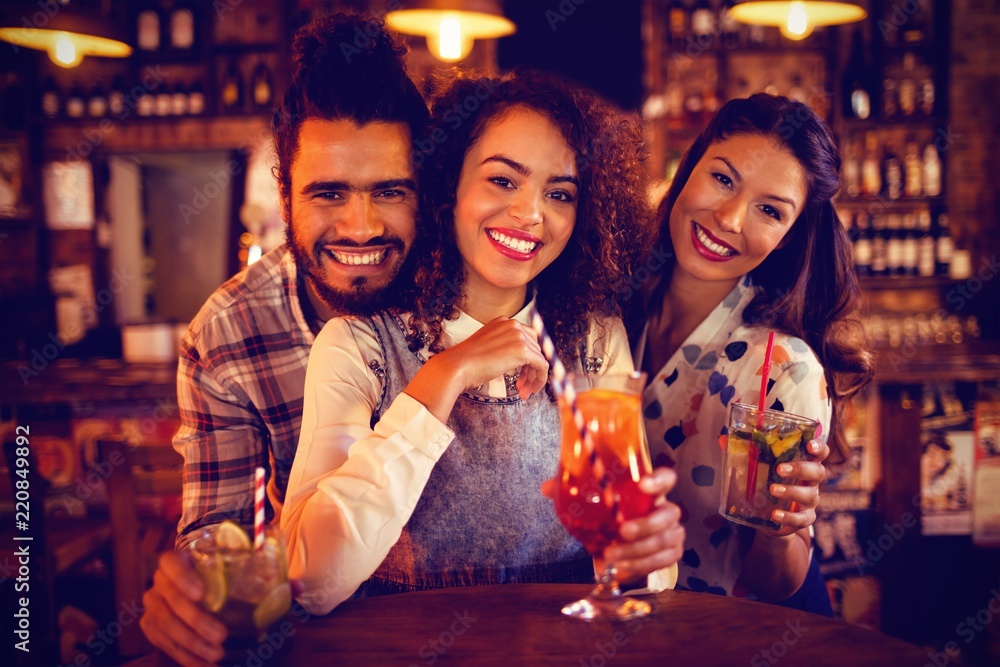 Portrait of young friends having drinks