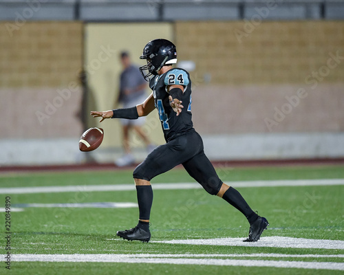 Football player kicking the ball during a game
