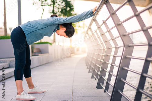 Photography Girl stretching before running in urban environment