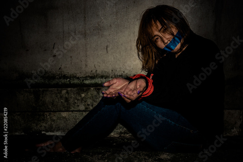 Fotografie, Tablou Asian hostage woman Bound with rope at night scene,The thieves kidnapped for ran