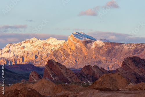 Fototapeta Naklejka Na Ścianę i Meble -  Sunset lights distant snow covered mountains