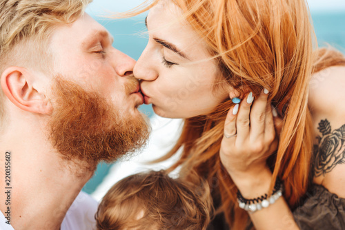 Wallpaper Mural Mom and Dad kiss. Happy family on vacation Torontodigital.ca