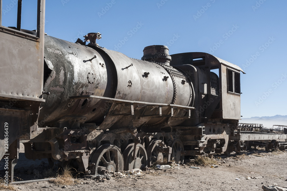 Rusty old and abandoned trains at the Train Cemetery (Cementerio de Trenes) in Uyuni desert, Bolivia - South America Rusty old and abandoned trains at the Train Cemetery (Cementerio de Trenes) in Uyuni desert, Bolivia - South America