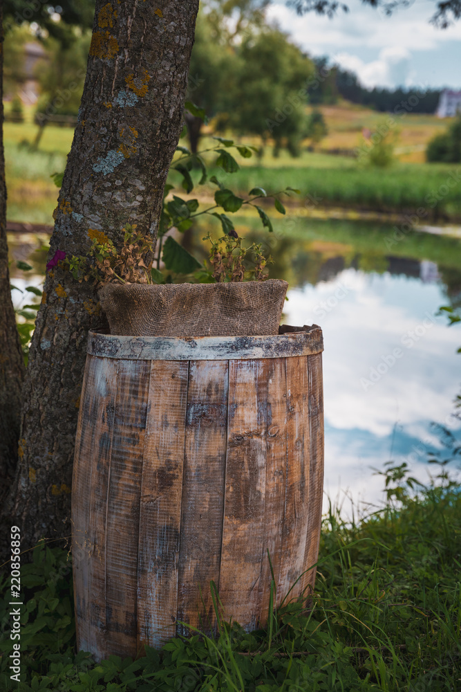 wooden old gray barrel on the nature near the lake wooden old gray barrel on the nature near the lake