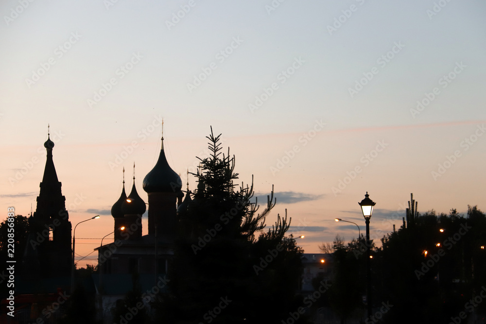 Church Of Our Lady Of Tikhvin. The Church Of St. Nicholas. Silhouettes in the light of sunset.