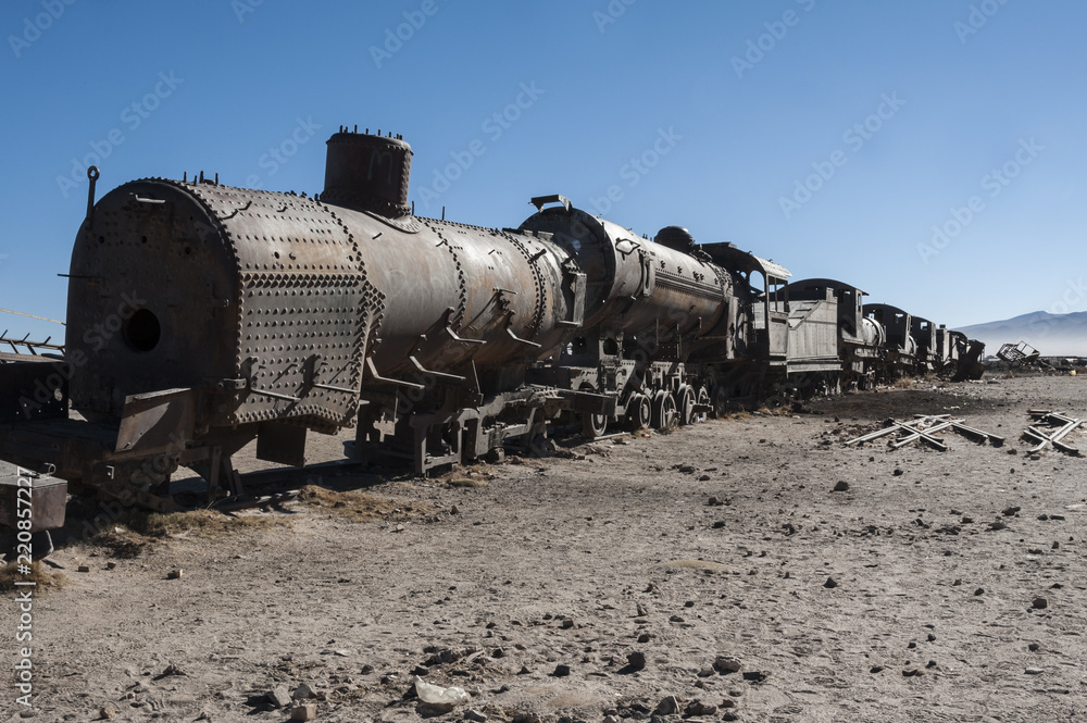 Rusty old and abandoned trains at the Train Cemetery (Cementerio de Trenes) in Uyuni desert, Bolivia - South America Rusty old and abandoned trains at the Train Cemetery (Cementerio de Trenes) in Uyuni desert, Bolivia - South America