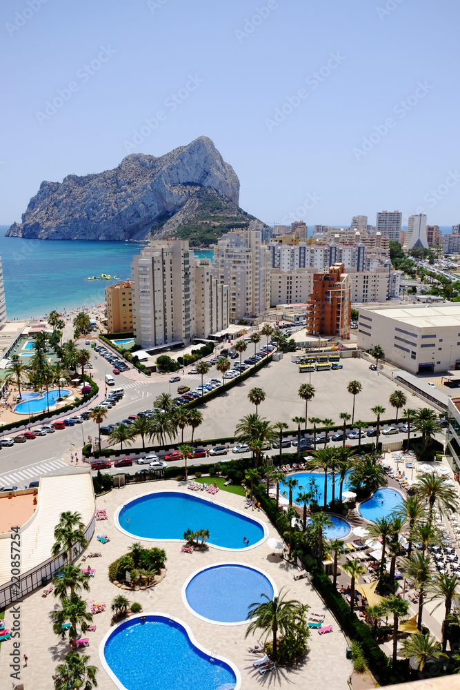 Calpe Spain  Top view of the city. Mountain Penon De Ifach. Mediterranian sea. Swimming pools. Buidings and streets.