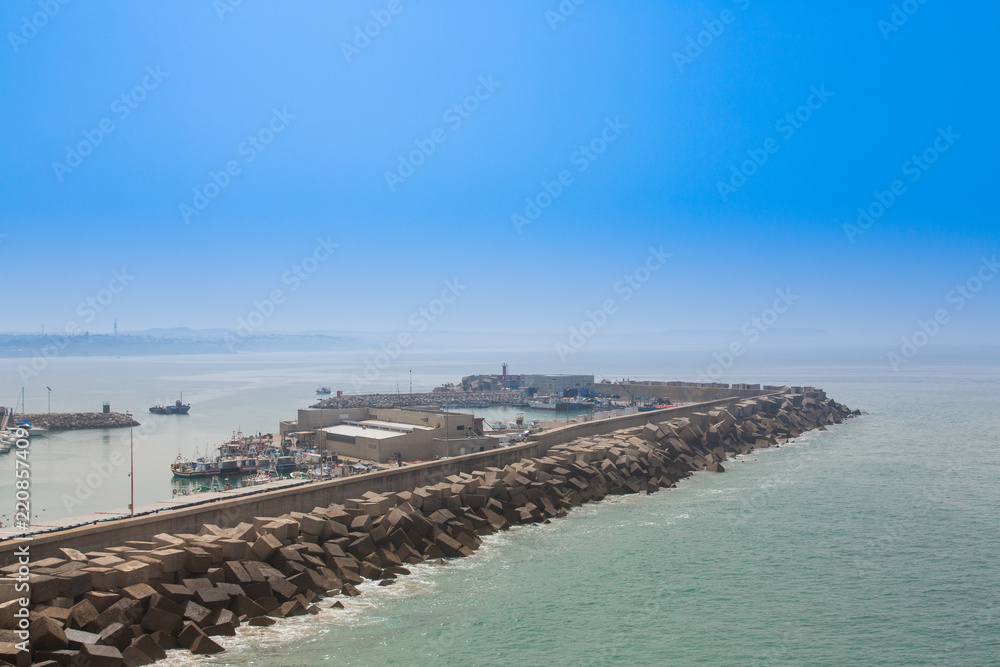 View from the lighthouse of Cape Roche of the nautical port and its breakwater, in Conil, Andalucia. Spain View from the lighthouse of Cape Roche of the nautical port and its breakwater, in Conil, Andalucia. Spain