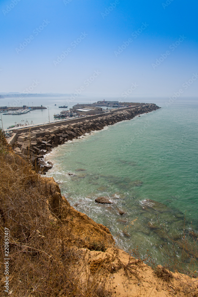 View from the lighthouse of Cape Roche of the nautical port and its breakwater, in Conil, Andalucia. Spain