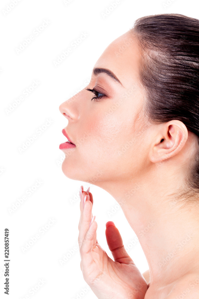 Beautiful young girl is holding her hand near the neck, isolated on white background Beautiful young girl is holding her hand near the neck, isolated on white background